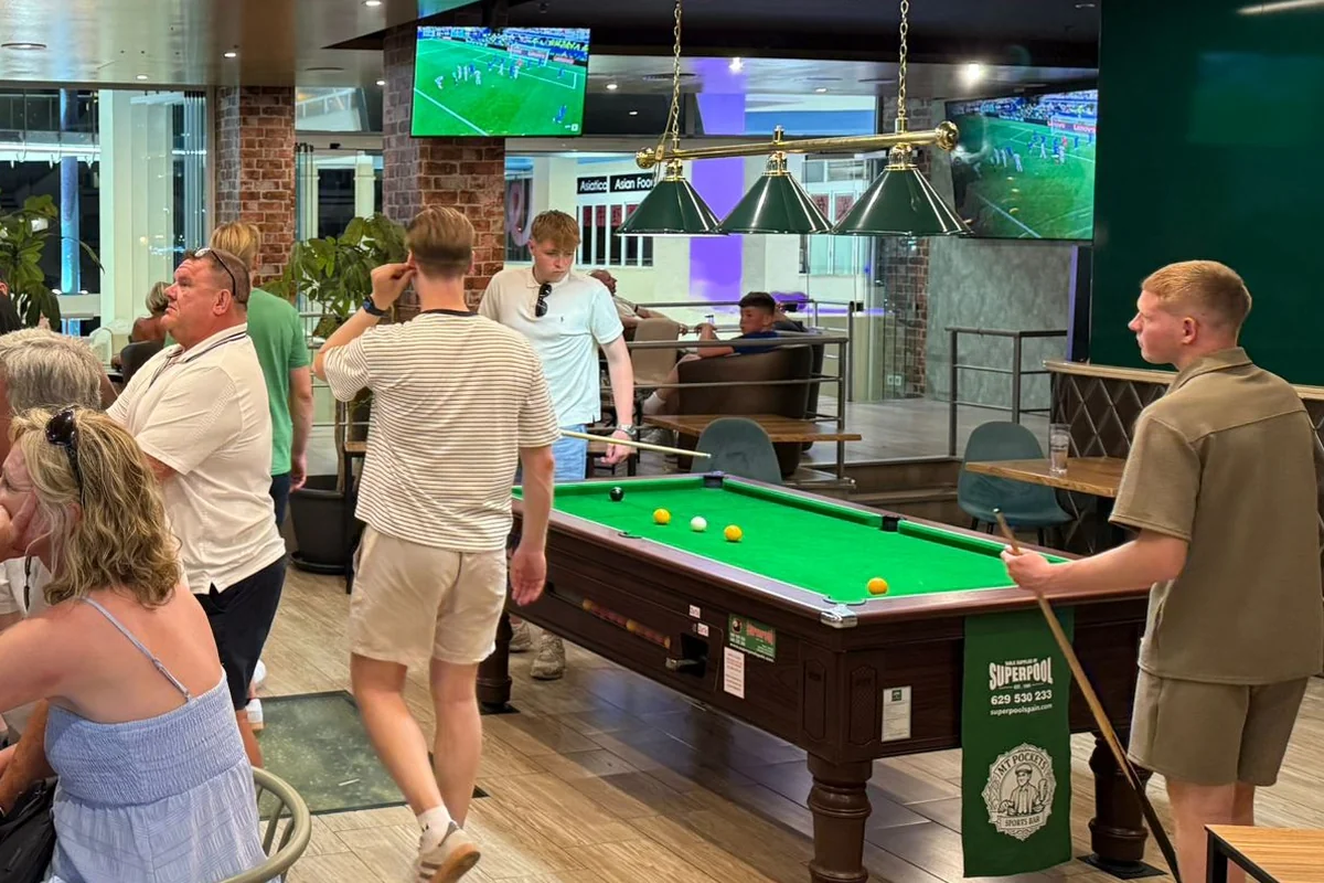 Lining up a shot on the pool table at MT Pockets, Benalmádena